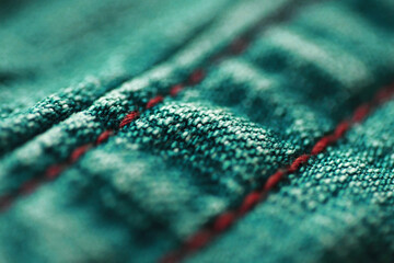 Green fabric textile texture close up , focus only one point , soft blured background
