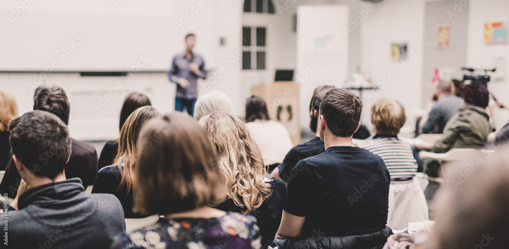 Wall mural Audience in lecture hall participating at business conference event