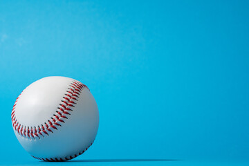 Close-up image of baseball ball on blue background in perspective. Minimalist photo of baseball...