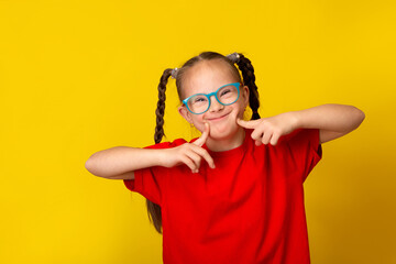 Happy girl with Down syndrome having fun and laughing in the studio