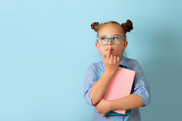 Happy girl with Down syndrome having fun in the studio with books