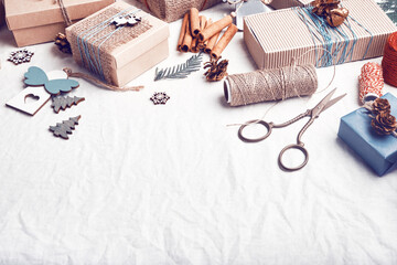 Christmas gifts on white crumpled fabric. Ecological packaging. Zero waste holidays.