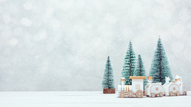 Christmas toy train travels through a miniature snowy forest