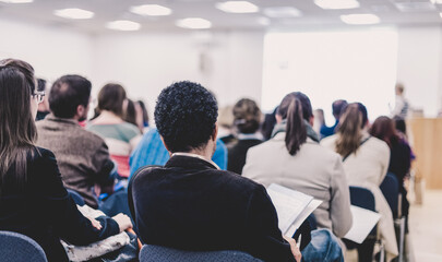 Woman giving presentation on business conference.