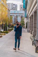 Fototapeta premium Stylish businessman in downtown having mobile call