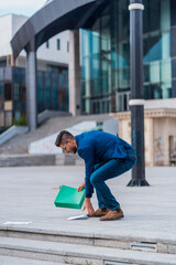 Friendly Caucasian businessman walking in the city talking on mobile phone