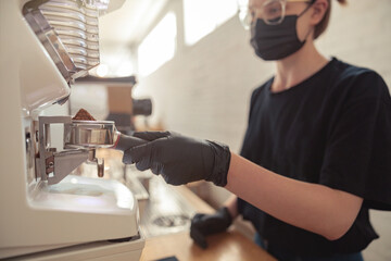 Woman holding stainless mug and using machine