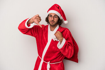 Young caucasian man disguised as santa claus isolated on gray background showing a dislike gesture, thumbs down. Disagreement concept.