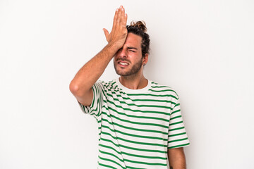 Young caucasian man isolated on white background forgetting something, slapping forehead with palm...