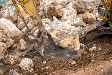 Excavator transports rock blocks