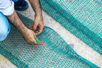 men doing fishing nets knit