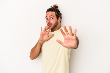 Young caucasian man isolated on white background being shocked due to an imminent danger