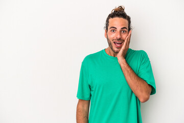 Young caucasian man isolated on white background shouts loud, keeps eyes opened and hands tense.