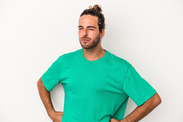 Young caucasian man isolated on white background frowning face in displeasure, keeps arms folded.