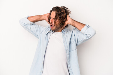 Young caucasian man isolated on white background screaming, very excited, passionate, satisfied...