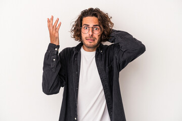 Young caucasian man isolated on white background screaming with rage.