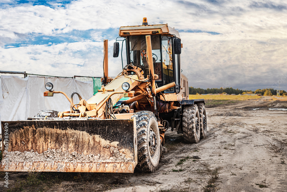 Wall mural Road grader - heavy equipment for road construction and earthworks. Leveling and improvement of the ground surface. Construction of roads and transport communications.