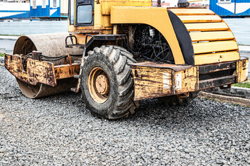 Fototapeta premium Heavy-duty vibratory roller for asphalt paving. Road construction. Construction of roads and urban transport communications. Heavy machinery.