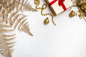 Christmas holidays composition with gold decorations on white background with copy space for your text
