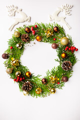 Fototapeta na wymiar Winter and christmas wreath with gold christmas toys on white background.