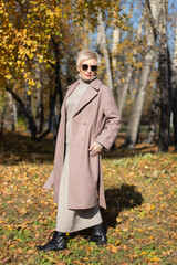 beautiful woman walks in the park in autumn