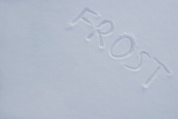 inscription of frost on the snow. children wrote frost in the snow. cold season.