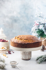 Traditional Christmas cake pudding with fruits and nuts with Christmas decorations, light background
