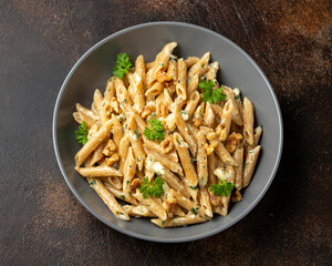 Whole Wheat Penne pasta with gorgonzola cheese sauce, spinach and walnut. Healthy food.
