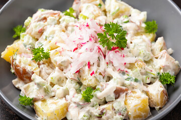 Potato salad with celery, green onion, radish, dill and eggs