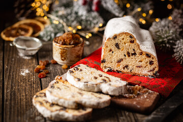 Christmas Stollen. Traditional Sweet Fruit Loaf with Icing Sugar. Xmas holiday table setting.