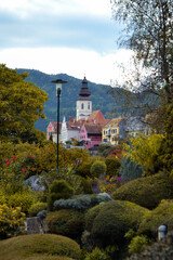 Fototapeta premium Fronleiten, a beautiful tourist town in Austria. Lake and mountains in the city in autumn.