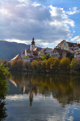 Fototapeta premium Fronleiten, a beautiful tourist town in Austria. Lake and mountains in the city in autumn.