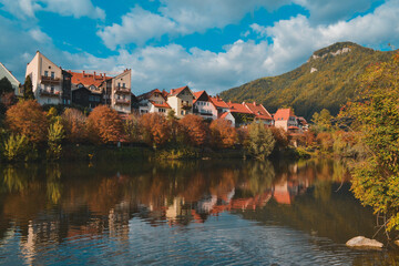 Naklejka na ściany i meble Fronleiten, a beautiful tourist town in Austria. Lake and mountains in the city in autumn.