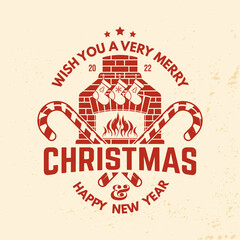 Obraz premium Wish you a very Merry Christmas and Happy New Year stamp, sticker, patch with fireplace, Christmas socks, christmas candy. Vector illustration. Vintage design for xmas, new year emblem in retro style.