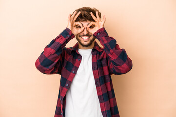 Young arab man isolated on beige background excited keeping ok gesture on eye.
