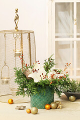 Christmas floral arrangement with white lilies, thuja twigs and golden baubles