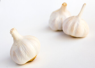 garlic heads and cloves on white background