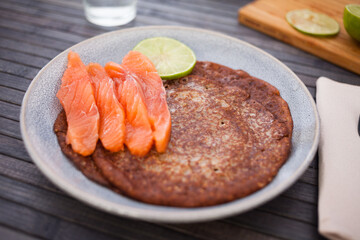salted salmon fillet with rye pancakes and lime