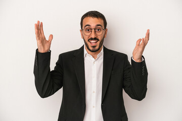 Young caucasian business man isolated on white background receiving a pleasant surprise, excited...