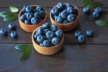 blueberries in wooden bowls close-up. fresh blueberries close-up. background with blueberries.