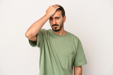 Obraz premium Young caucasian man isolated on white background forgetting something, slapping forehead with palm and closing eyes.