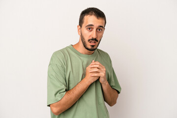 Young caucasian man isolated on white background scared and afraid.