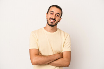 Fototapeta premium Young caucasian man isolated on white background who feels confident, crossing arms with determination.