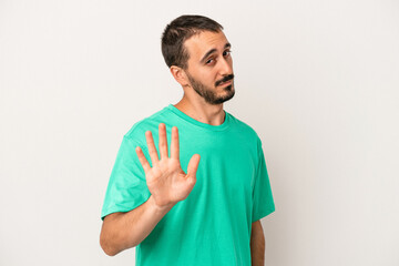 Young caucasian man isolated on white background rejecting someone showing a gesture of disgust.