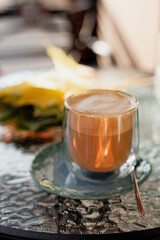 autumn coffee in a transparent cup with sweets