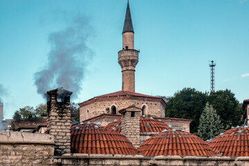 Dome-shaped roof made of minarets and tiles.