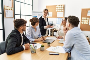 Group of young business workers listening boss speech during meeting at the office.