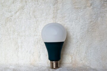 light bulb on fluffy white fur texture background