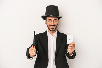 Young magician man holding wand and magic card isolated on white background