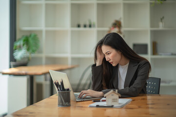 Asian businesswoman gets stressed while having a problem at work in the office.